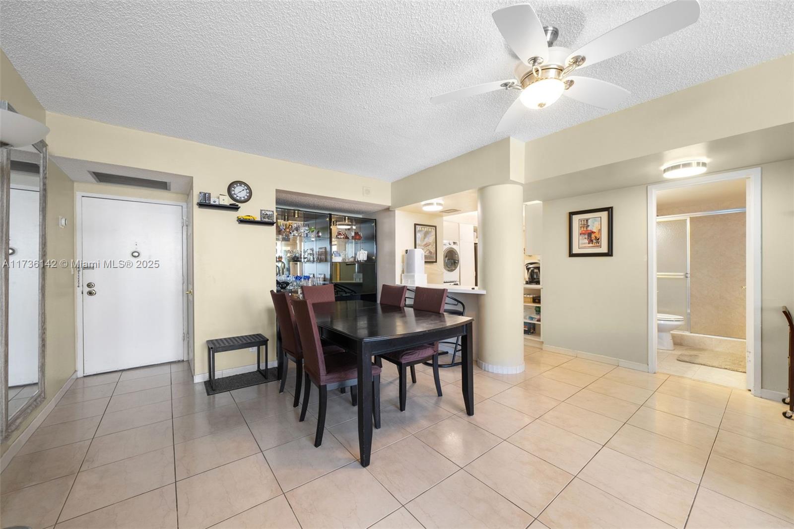 A dining area features a dark wood table, chairs, tile flooring, and a ceiling fan — 3725 S Ocean Dr # 1110, Hollywood FL 33019, HOLLYWOOD, FL