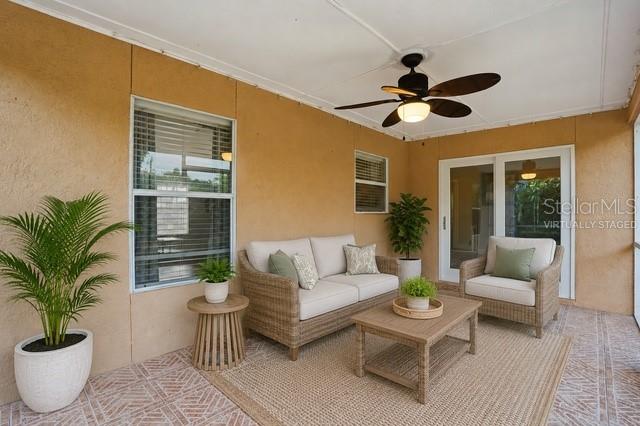 A furnished covered patio features wicker furniture, a ceiling fan, and a tiled floor — 4934 SW 20TH PLACE, CAPE CORAL, FL