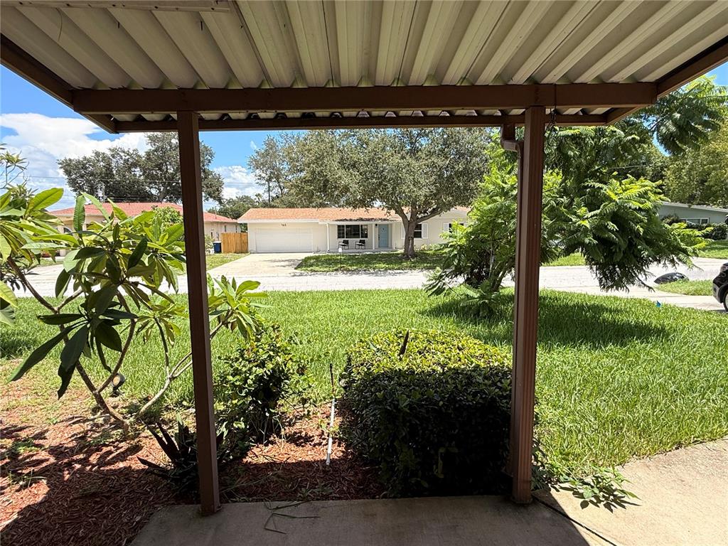 A view from a covered porch looking out at a residential street and house — 164 PINEWOOD AVENUE, CLEARWATER, FL