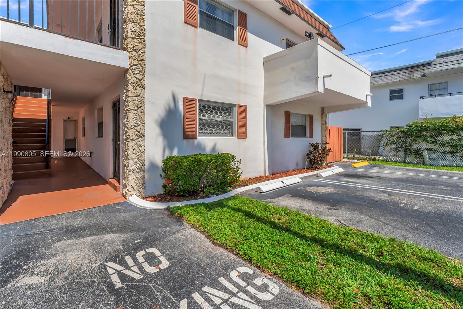The exterior view shows a multi-story apartment building with a parking area and stairs — 321 SW 1st Ct # 4, Pompano Beach FL 33060, POMPANO BEACH, FL