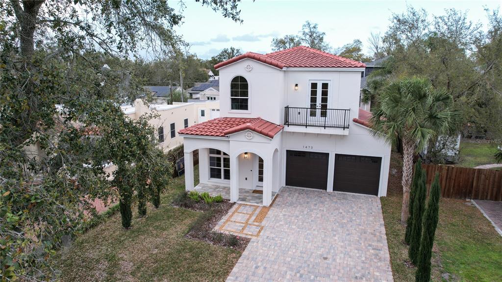 An exterior view of a two-story white stucco house with a red tile roof — 1473 BERKSHIRE AVENUE, WINTER PARK, FL