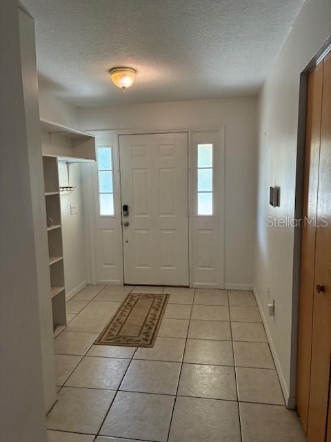 An entryway features a white front door with sidelights, tiled flooring, and built-in shelving — 20929 SW AUDUBON AVENUE, DUNNELLON, FL