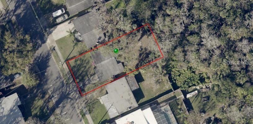 An aerial view shows a residential lot outlined in red with a house and vegetation — 765 GREENWAY PLACE, DAYTONA BEACH, FL