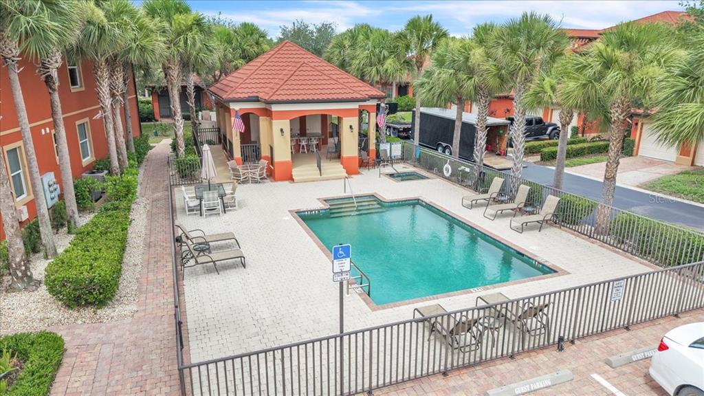 An aerial view of a swimming pool area with a covered pavilion and lounge chairs — 3500 MONDOVI COURT UNIT 811, PUNTA GORDA, FL
