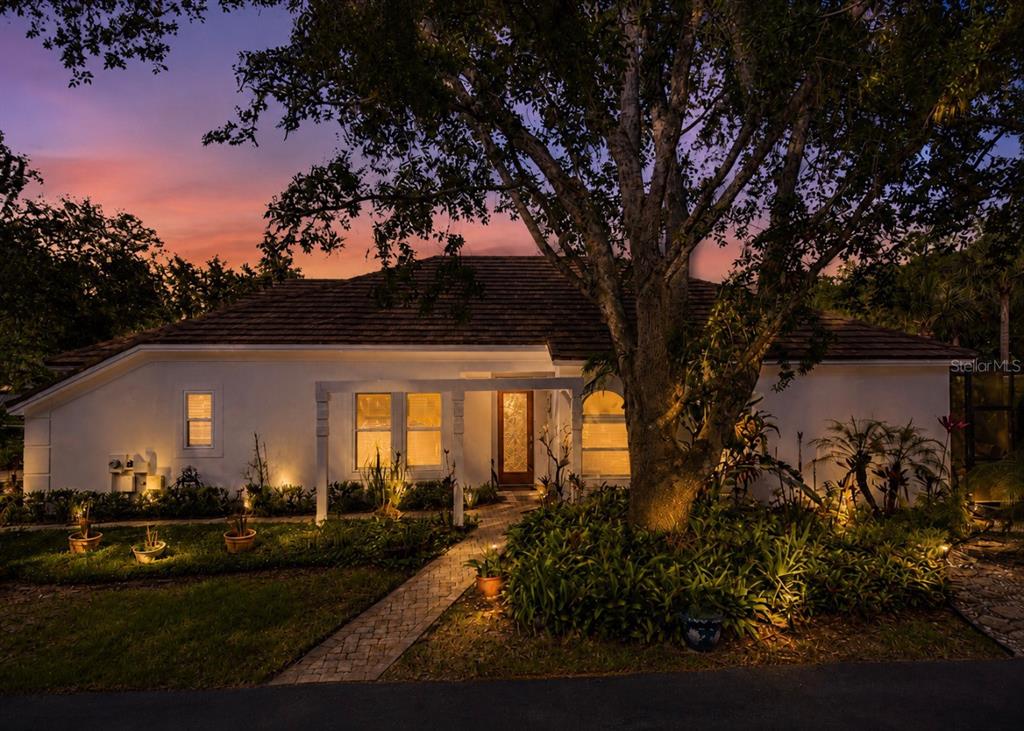 A single-story house with a white exterior, a tiled roof, and a large front tree — 5204 GREEN FOREST COURT, TAMPA, FL