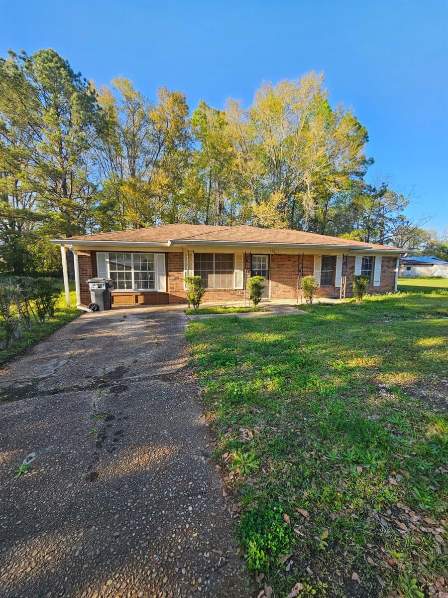 A single-story brick house with a concrete driveway and a large front yard — 503 Martin Luther King Junior Avenue, FL 32425, FL