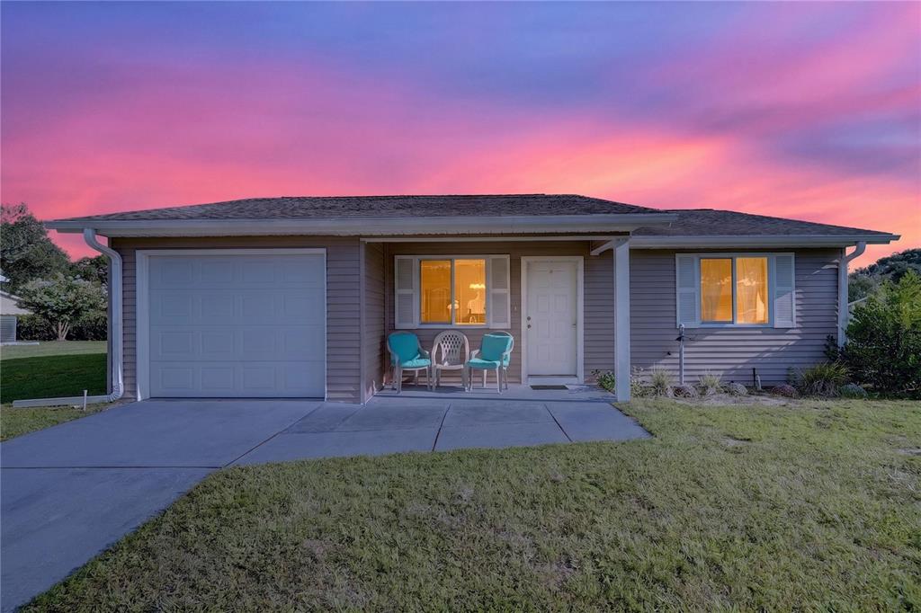 A single-story house with gray siding, a one-car garage, and a small front porch — 8392 SW 108TH LANE, OCALA, FL