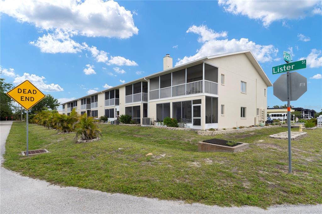 A two-story apartment building with screened balconies sits next to a dead end sign — 22278 VICK STREET UNIT A112, PUNTA GORDA, FL