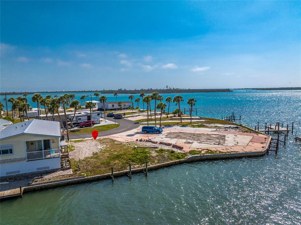 An aerial view shows a waterfront lot with a red marker and adjacent mobile homes — 7500 PARK POINTE DRIVE UNIT 42, ENGLEWOOD, FL