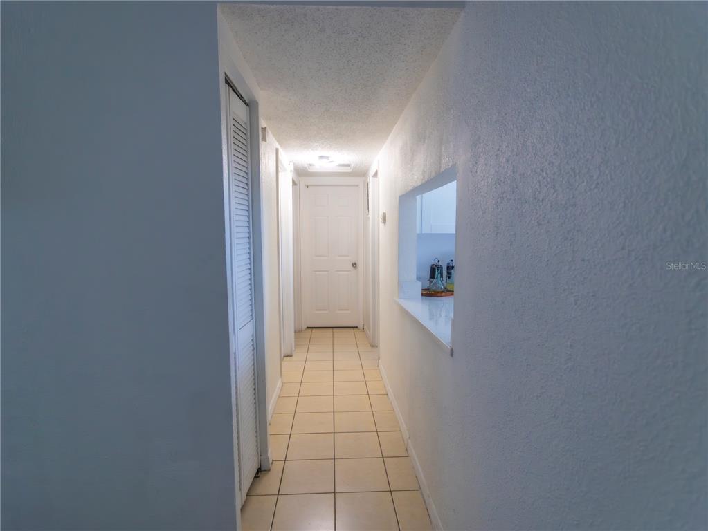 A single-story white house with a concrete driveway and a front lawn — 4718 ELDORADO DRIVE, TAMPA, FL