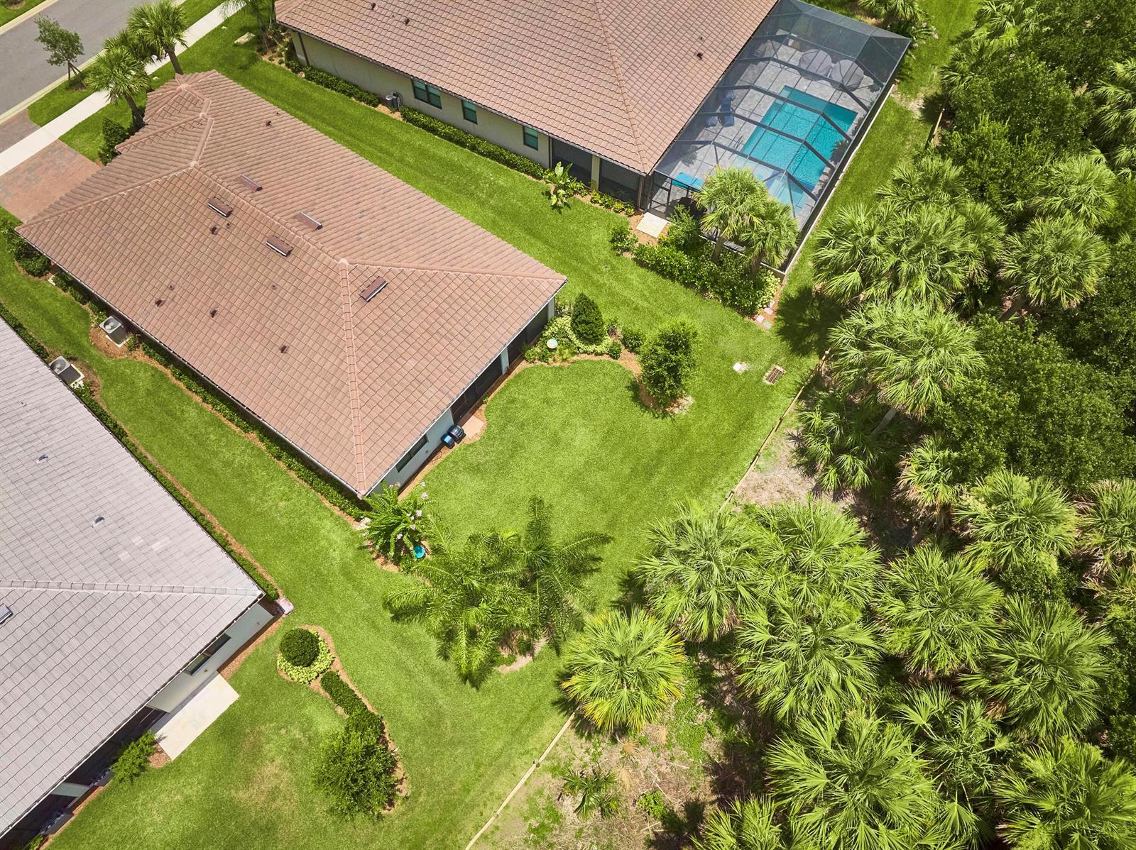 An aerial view shows a community clubhouse with a swimming pool, tennis courts, and parking — 3862 White Alder Way, Vero Beach FL 32967, VERO BEACH, FL