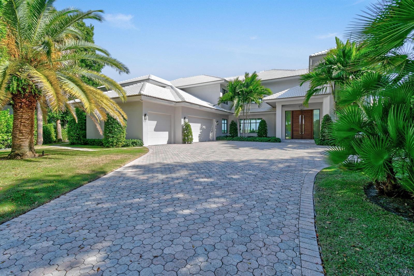 A two-story house with a white exterior, tiled roof, and a paved circular driveway — 101 Bowsprit Drive, North Palm Beach FL 33408, NORTH PALM BEACH, FL