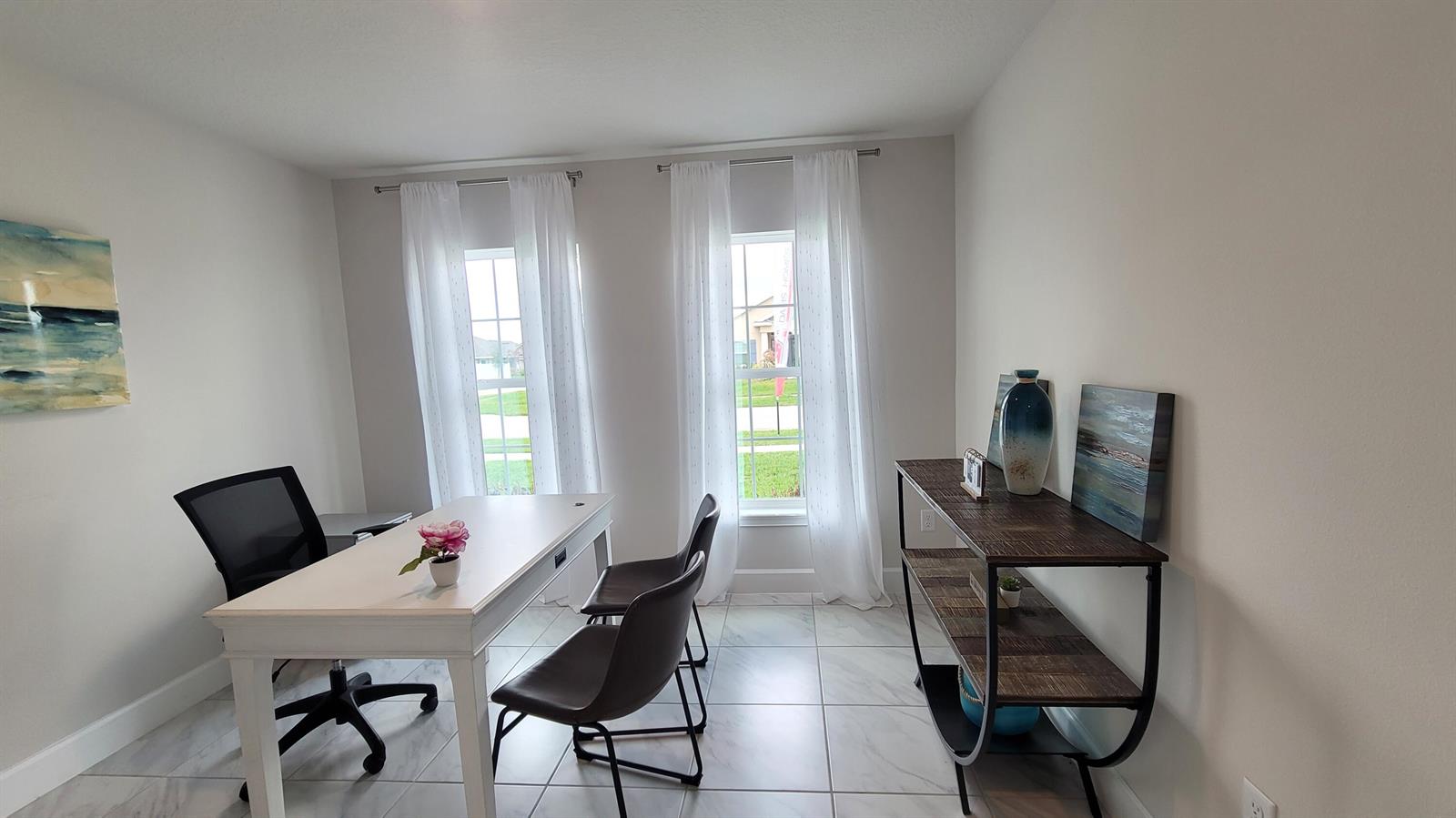 A home office features a white desk, two chairs, a shelving unit, and two windows — 8820 Waterstone Boulevard, Fort Pierce FL 34951, FORT PIERCE, FL