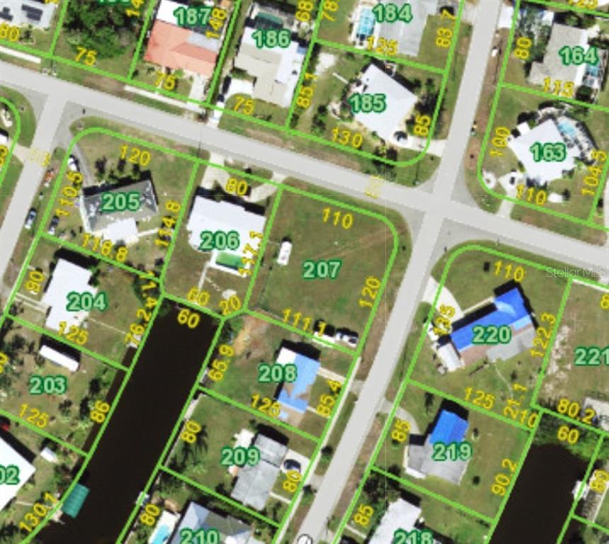 This is an aerial map showing residential lots and canal frontage in a neighborhood — 144 BUCKEYE AVENUE NW, PORT CHARLOTTE, FL
