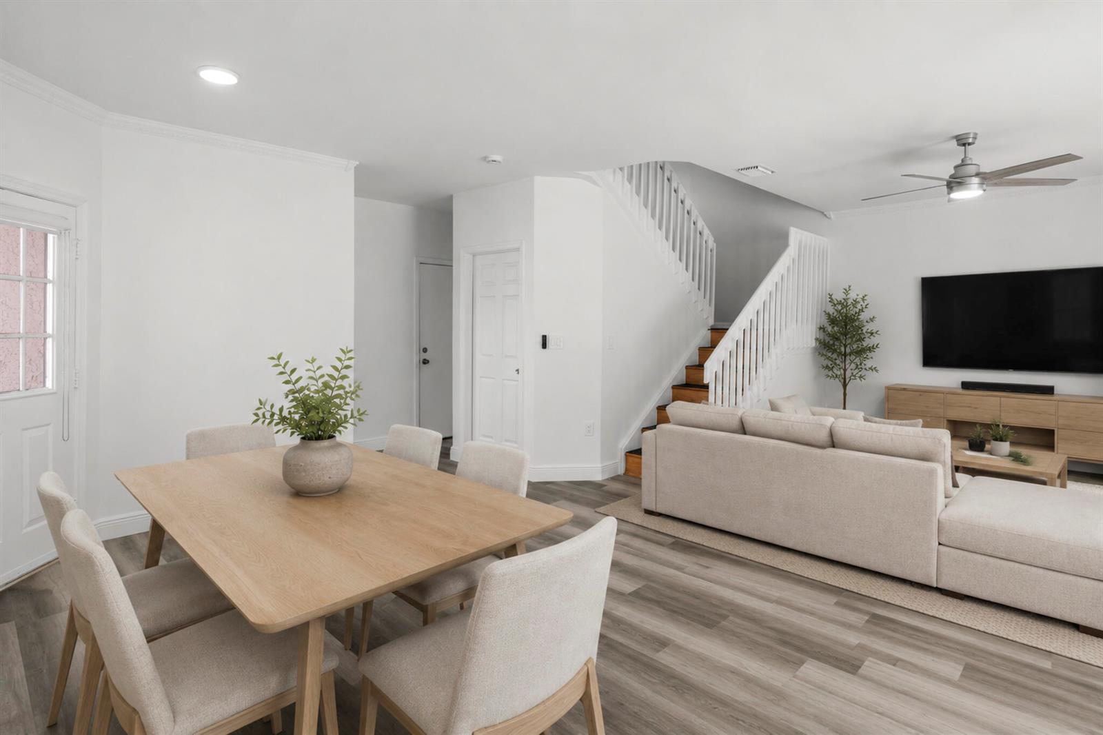 A dining area and living room feature light wood furniture, white walls, and wood-look flooring — 20970 Via Oleander # D, Boca Raton FL 33428, BOCA RATON, FL