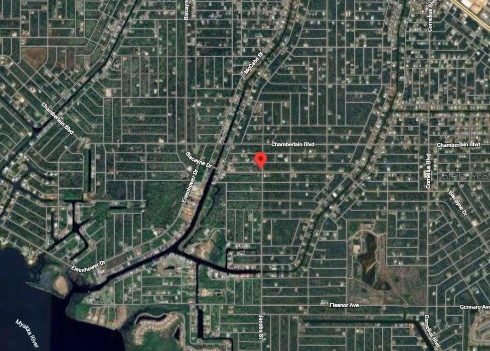 This is an aerial map view of a residential neighborhood with a red location pin — 1087 JACOBS STREET, PORT CHARLOTTE, FL