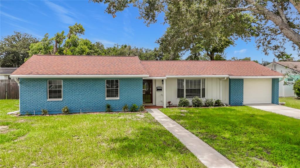 A single-story house with a blue brick facade, white siding, and a brown shingled roof — 514 W HILDA DRIVE, BRANDON, FL