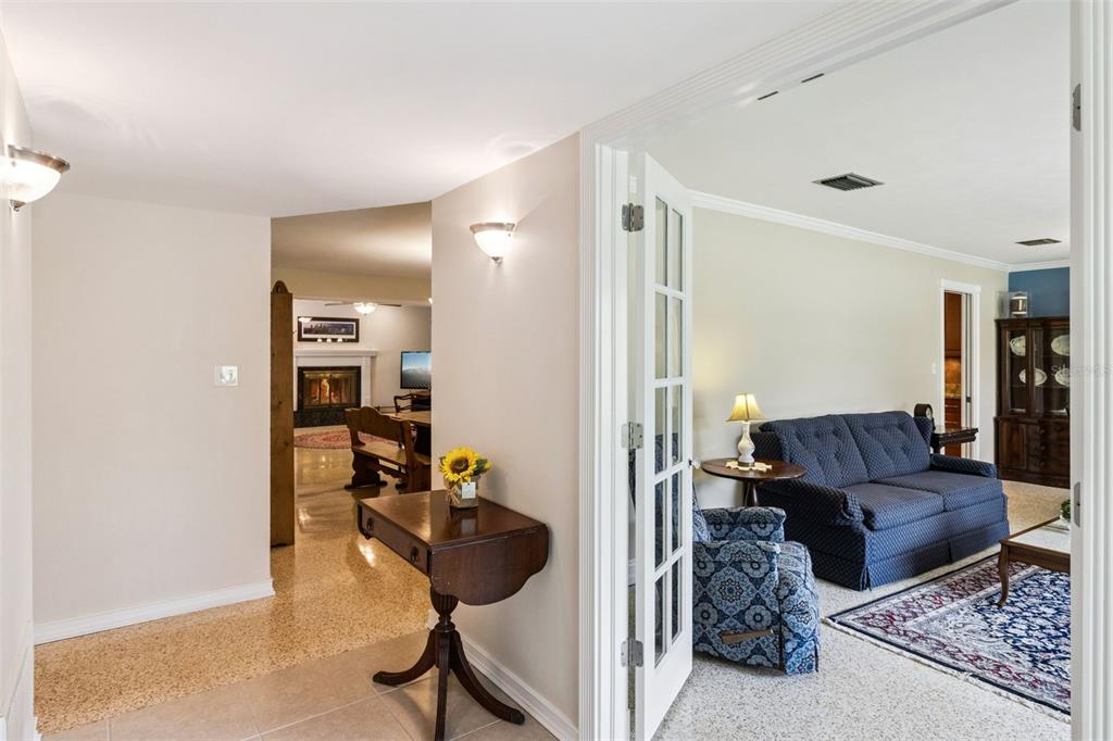 A view from a hallway into a living room and a dining area with a fireplace — 101 RONELE DRIVE, BRANDON, FL