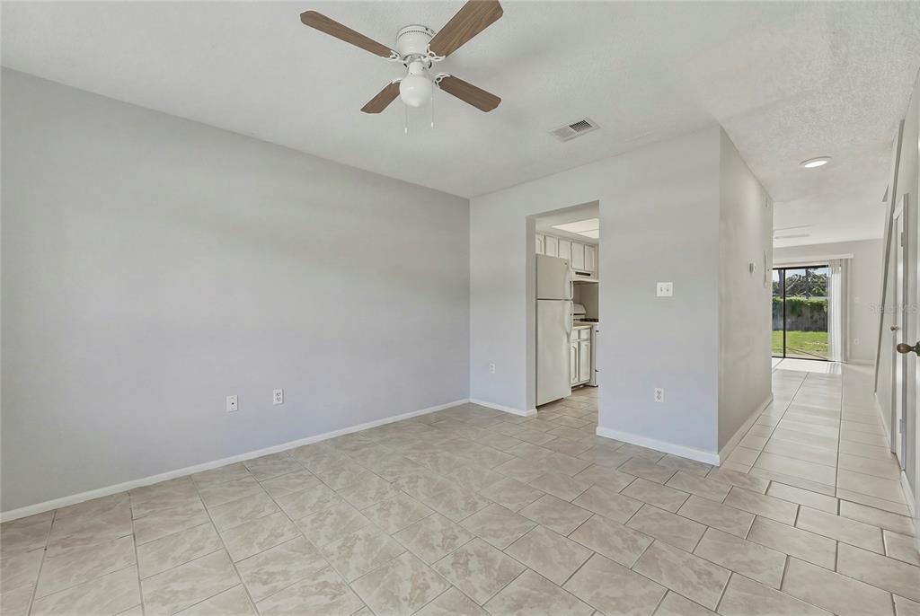 An empty room with light gray walls, tile flooring, and a ceiling fan — 4799 SISSON ROAD, TITUSVILLE, FL