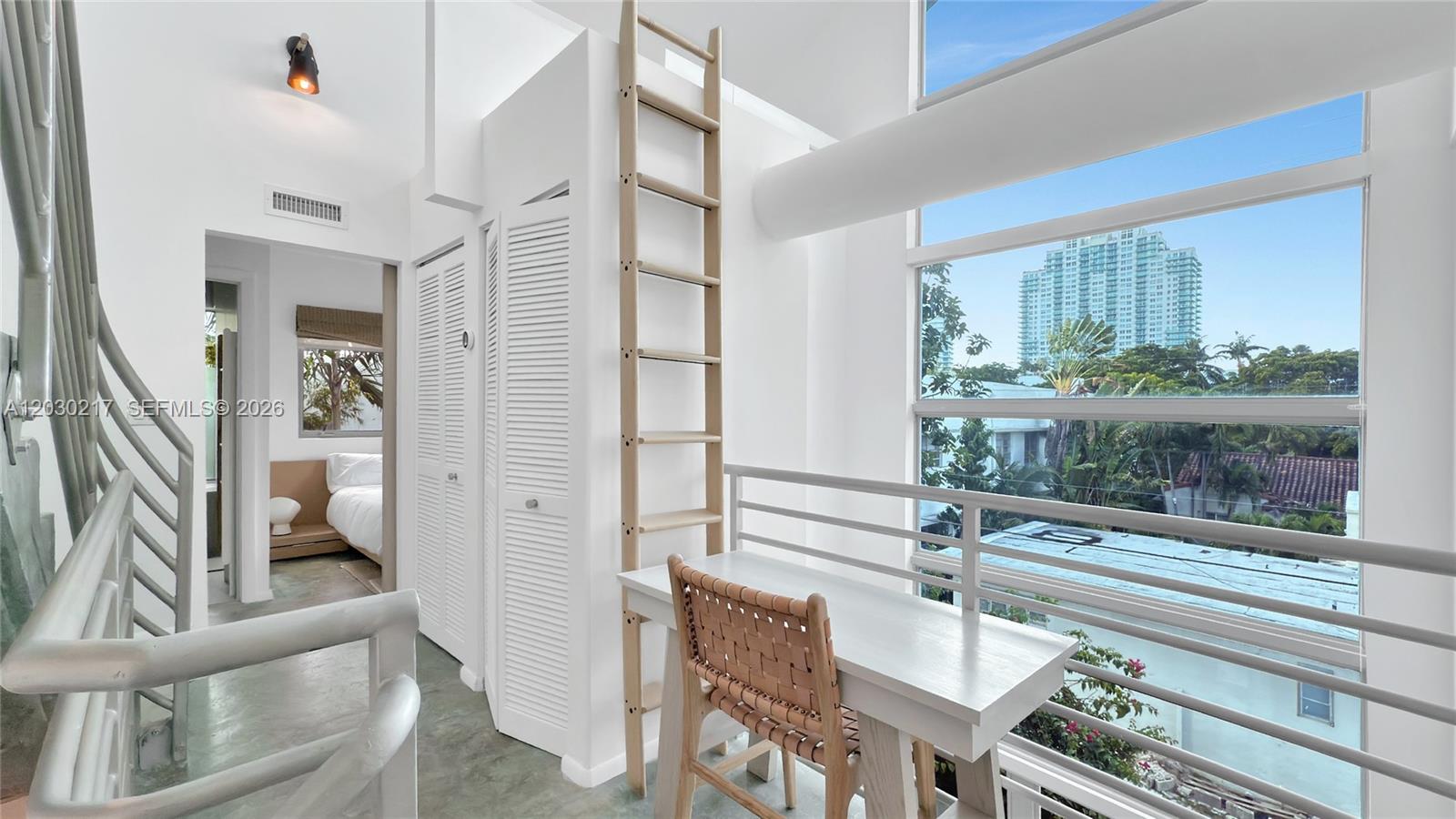 A modern white building features blue balconies and a tall, multi-paneled blue glass window — 734 Michigan Ave, Miami Beach FL 33139, MIAMI BEACH, FL