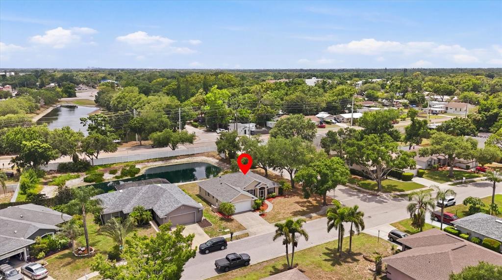 An aerial view shows a single-story house with a gray roof and a two-car garage — 2404 50TH DRIVE E, BRADENTON, FL
