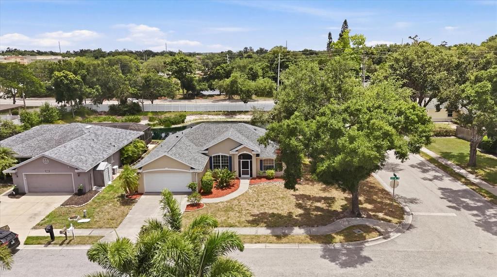 An entryway with white walls, wood flooring, a tiled foyer, and decorative white columns — 2404 50TH DRIVE E, BRADENTON, FL