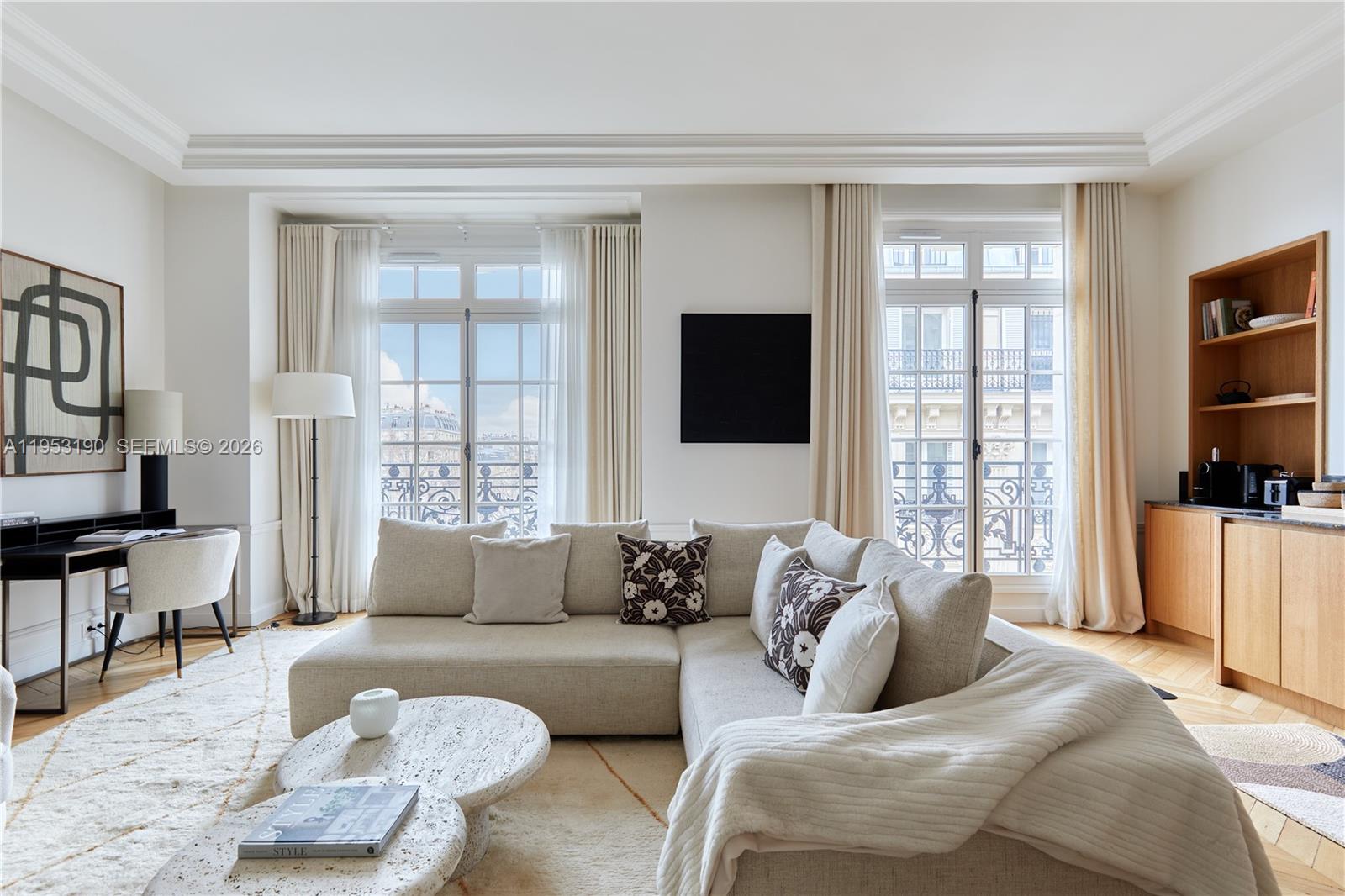 A bright living room features a sectional sofa, two coffee tables, and large French windows — 11 Rue St Dominique # 403, FR, FR