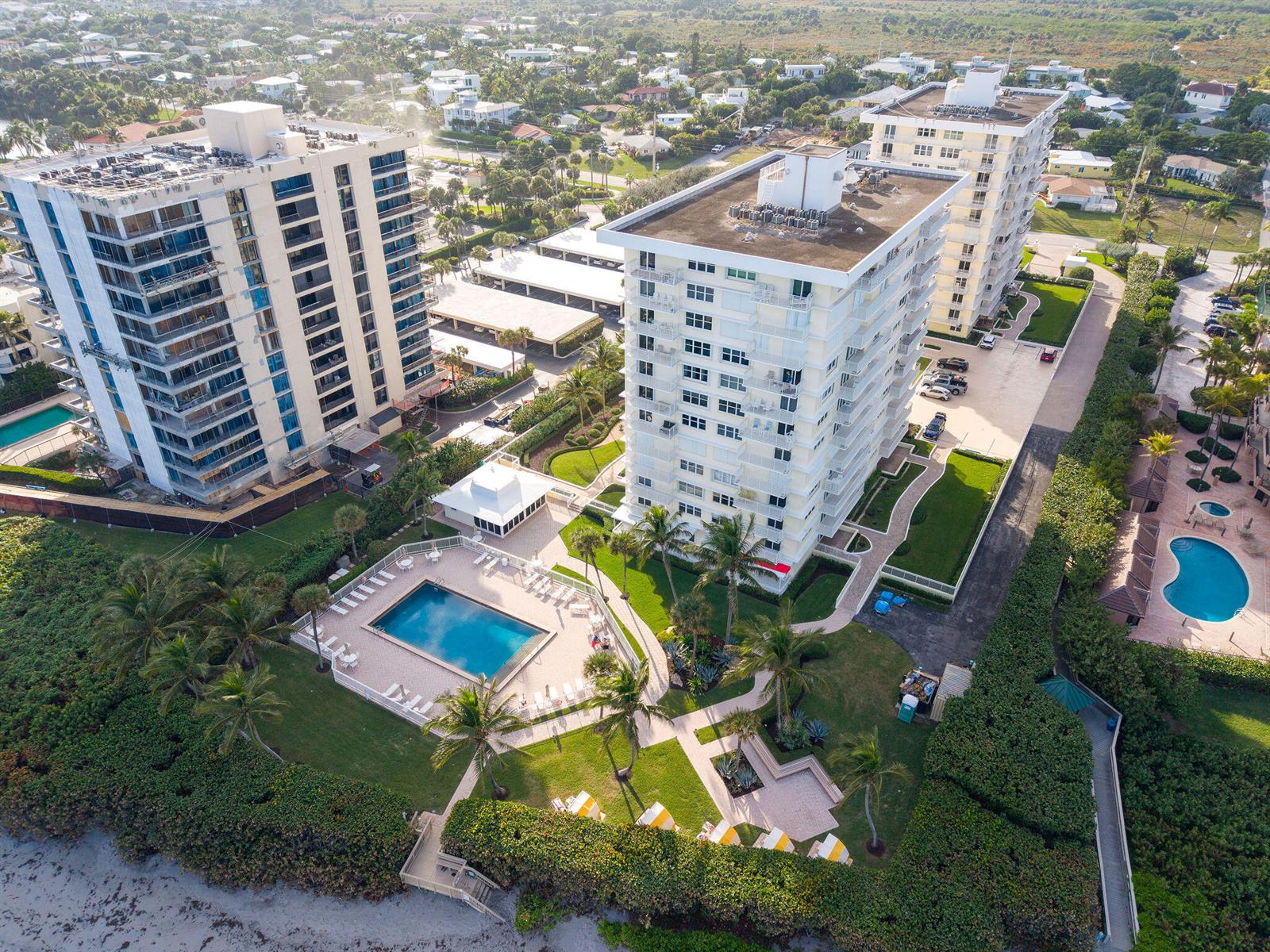 Aerial view of two high-rise apartment buildings with swimming pools and landscaped grounds near beach — 500 Ocean Drive # 2d, Juno Beach FL 33408, JUNO BEACH, FL
