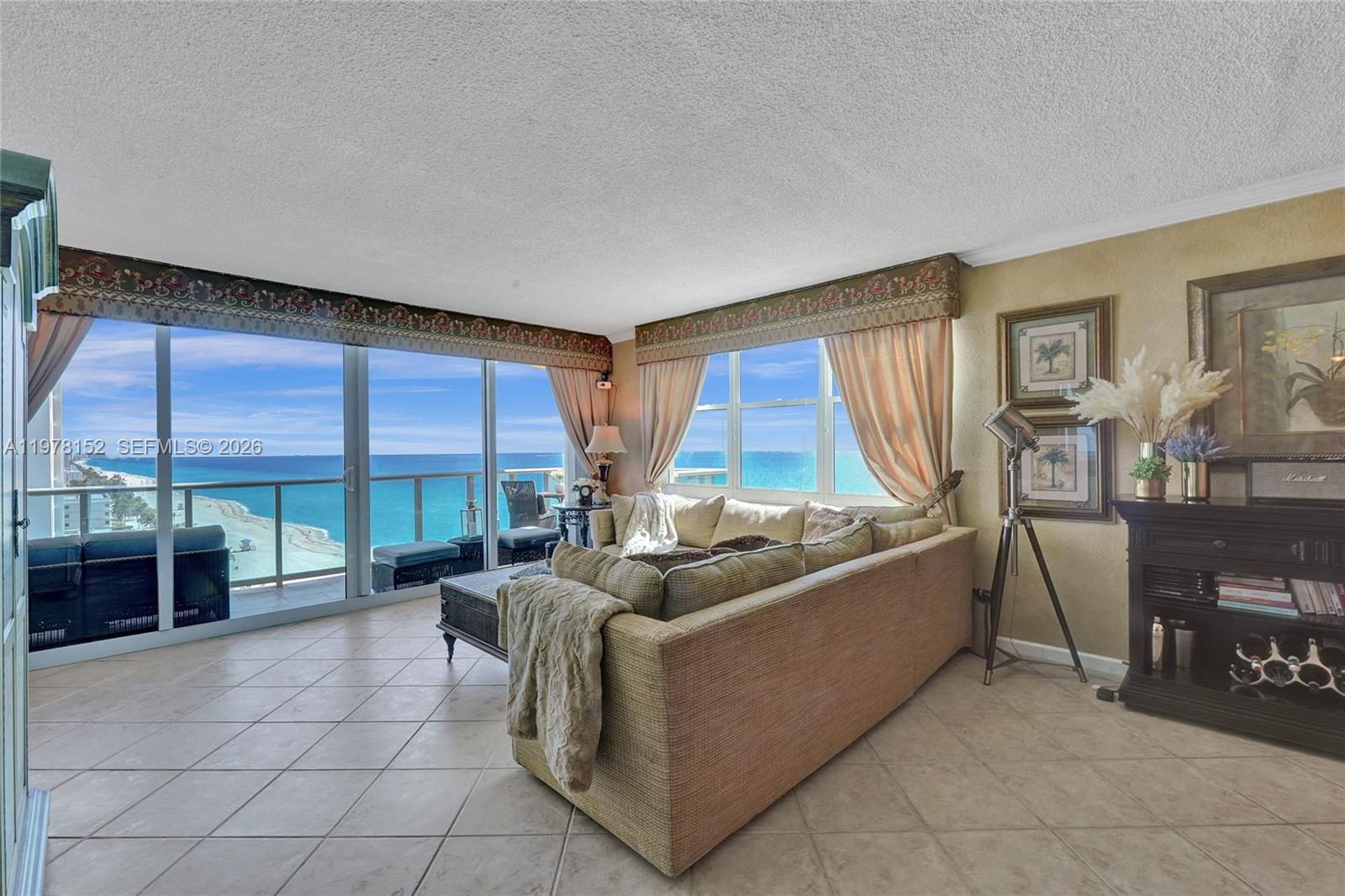A living room features a large sectional sofa, tile flooring, and floor-to-ceiling windows overlooking the ocean — 2501 S Ocean Dr # 1510, Hollywood FL 33019, HOLLYWOOD, FL