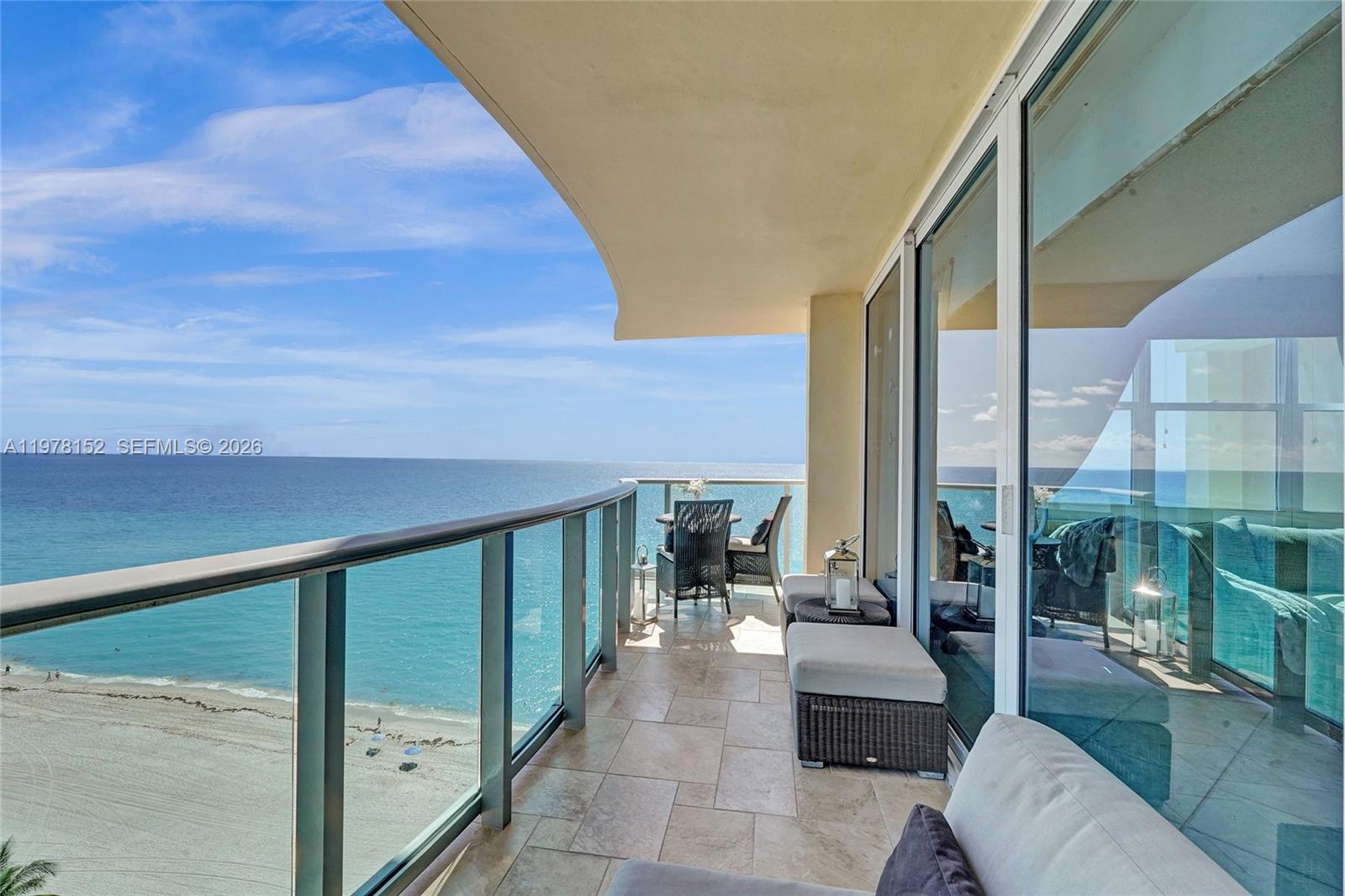 A balcony with tile flooring, outdoor furniture, and a glass railing overlooking the ocean — 2501 S Ocean Dr # 1510, Hollywood FL 33019, HOLLYWOOD, FL