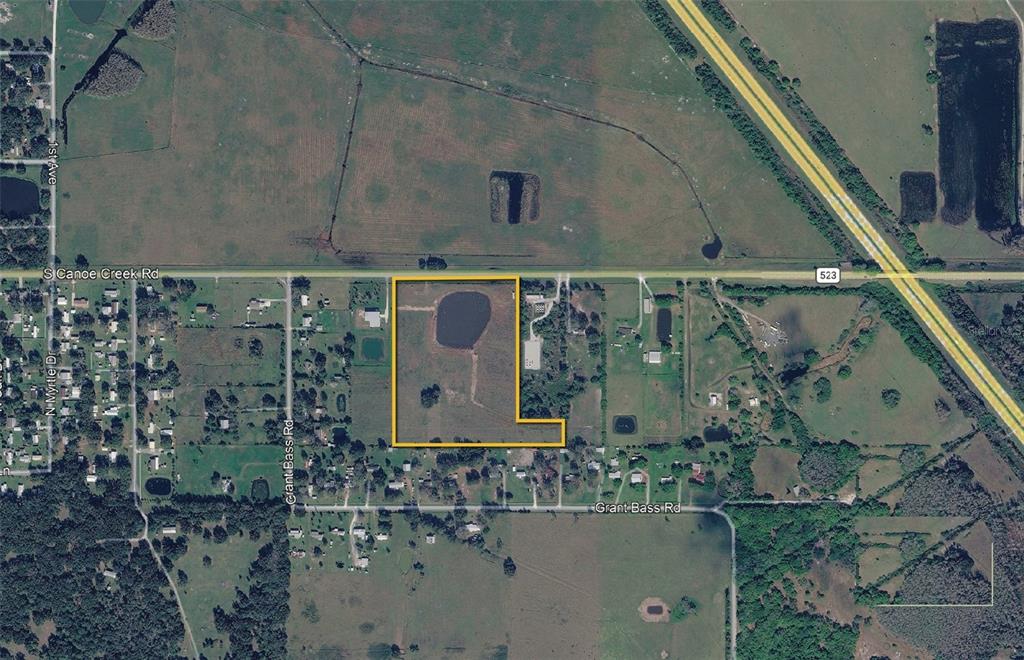 This aerial map shows a rectangular parcel of land with a pond along a road — 350 S CANOE CREEK ROAD, KENANSVILLE, FL