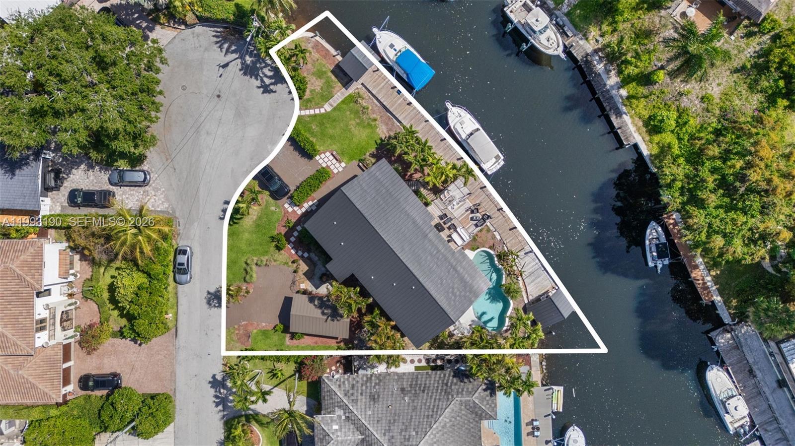 This aerial view shows a waterfront residential property with a pool, dock, and boat slips — 516 NE 6th Ave, Deerfield Beach FL 33441, DEERFIELD BEACH, FL