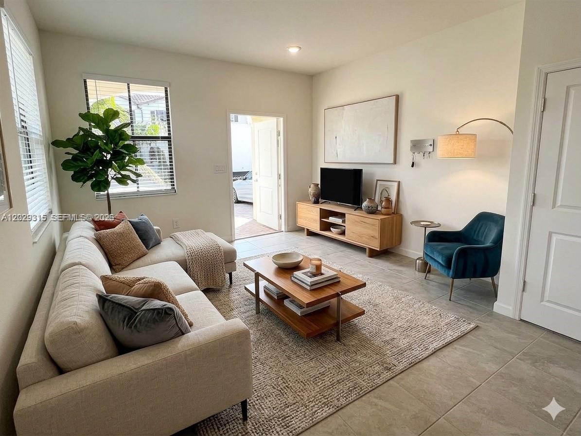 A living room features a beige sofa, wooden coffee table, blue armchair, and tile flooring — 24600 SW 119th Pl # 0, Miami FL 33032, MIAMI, FL