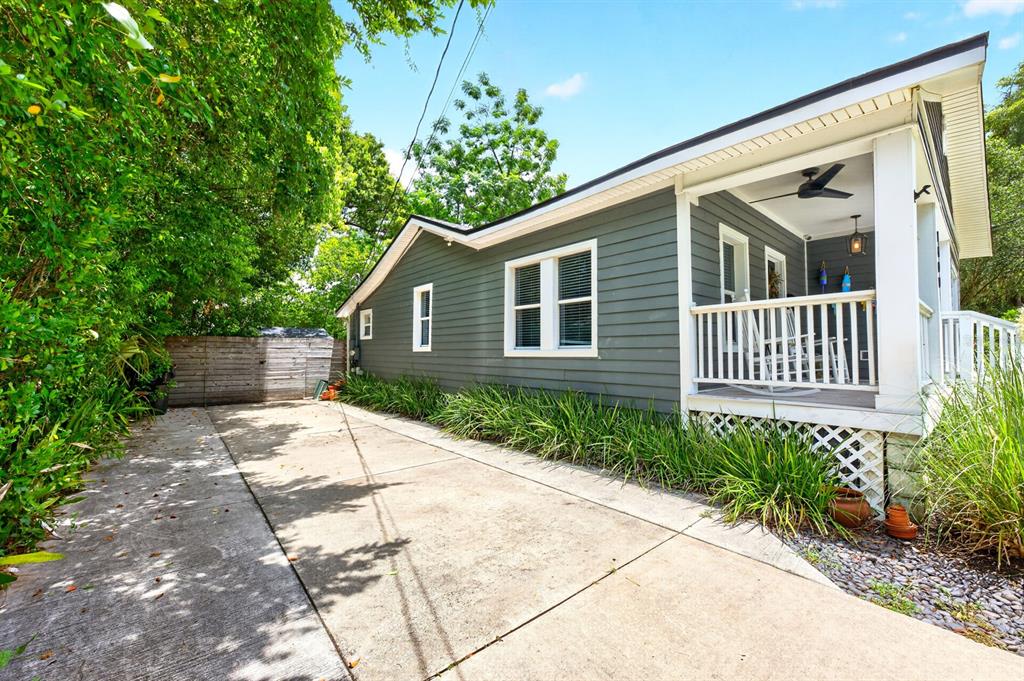 A side view of a gray house with a concrete driveway and a covered porch — 1409 E GORE STREET, ORLANDO, FL