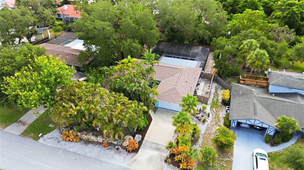 An aerial view shows a single-story house with a screened pool and lush landscaping — 3629 EGERTON CIRCLE, SARASOTA, FL