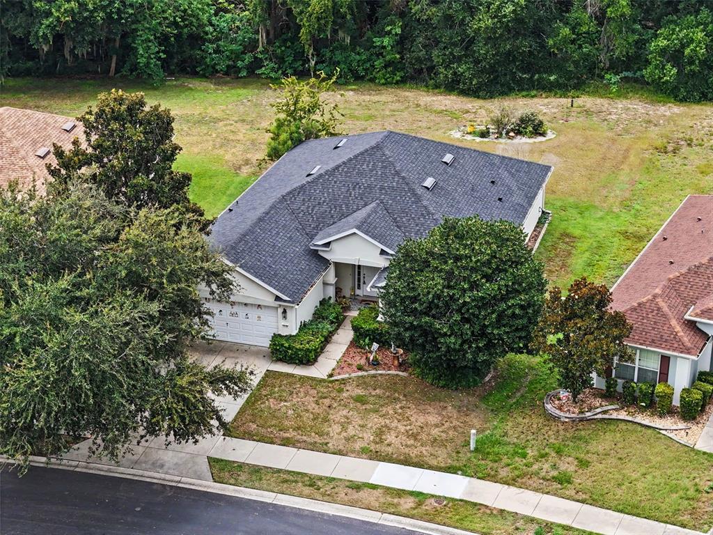 An aerial view shows a single-story house with a dark shingled roof and driveway — 5520 SW 45TH STREET, OCALA, FL