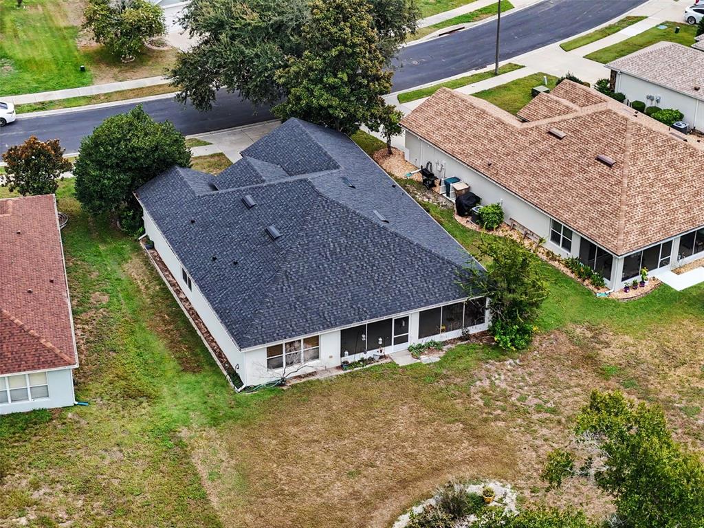 An aerial view shows a single-story house with a dark shingled roof and screened patio — 5520 SW 45TH STREET, OCALA, FL