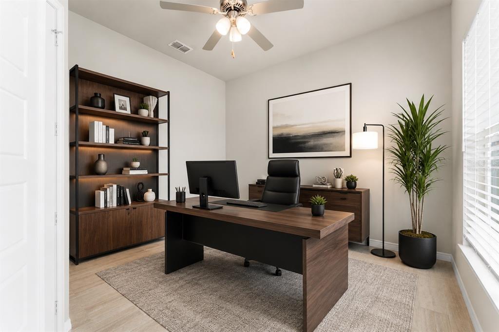 A home office features a dark wood desk, matching bookshelf, black chair, and a potted plant — 6436 SW 77TH STREET, GAINESVILLE, FL