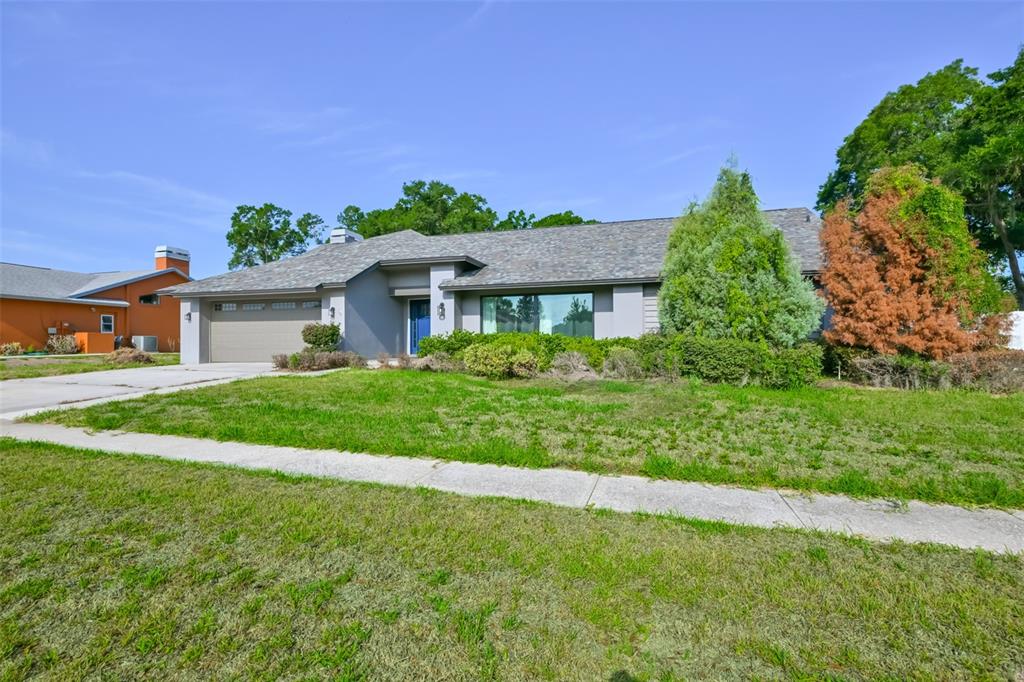 A single-story house with a gray exterior, a two-car garage, and a front lawn — 2701 HERNDON STREET, VALRICO, FL