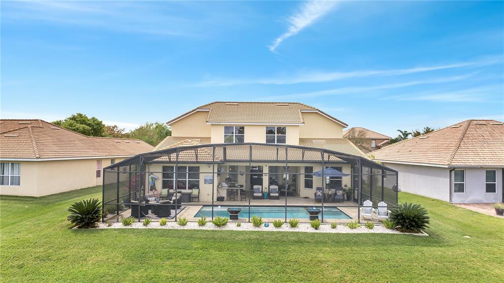 A two-story house with a screened-in pool and patio area in the backyard — 3790 EAGLE ISLE CIRCLE, KISSIMMEE, FL