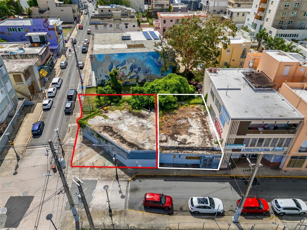An aerial view shows two adjacent, flat-roofed commercial buildings with graffiti in an urban setting — 1053 BRUMBAUGH, SAN JUAN, PR