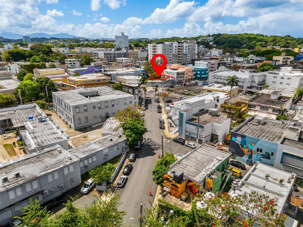 An aerial view shows a city street with buildings and a red location pin — 1053 BRUMBAUGH, SAN JUAN, PR