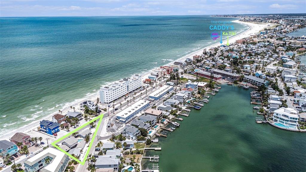 This aerial view shows a coastal neighborhood with a highlighted property near the beach — 8425 W GULF BOULEVARD, TREASURE ISLAND, FL