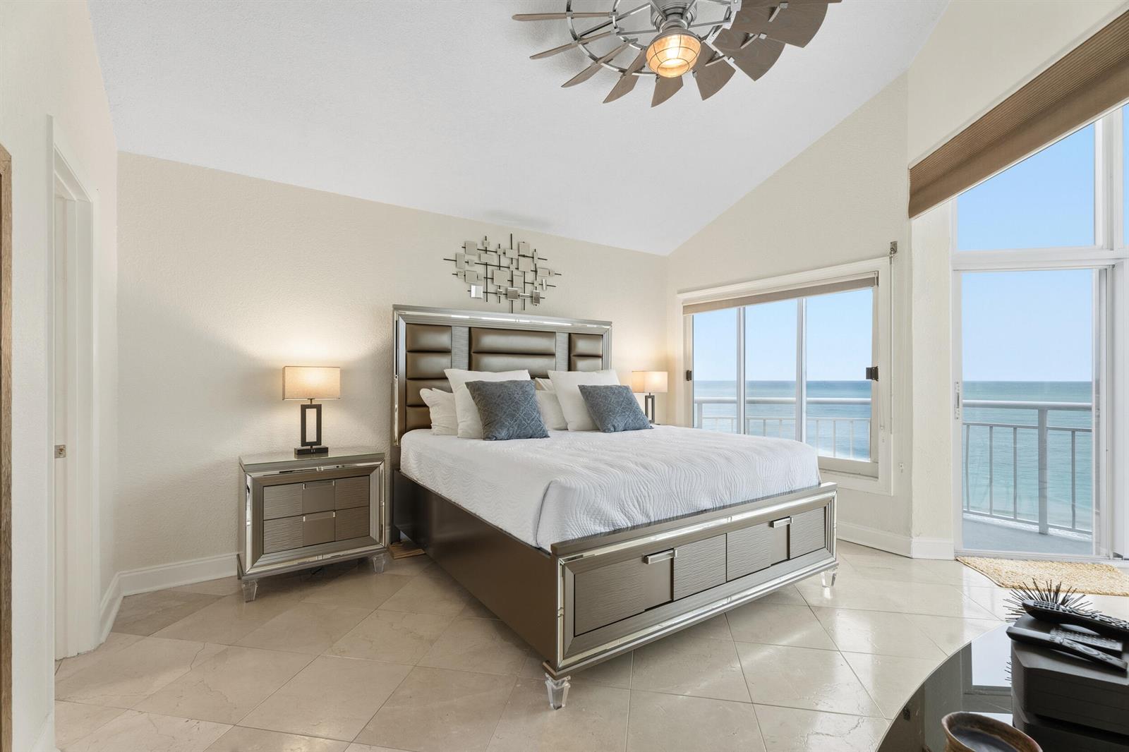A bedroom with a king bed, mirrored nightstands, and a balcony overlooking the ocean — 3870 N Highway A1a, Fort Pierce FL 34949, FORT PIERCE, FL