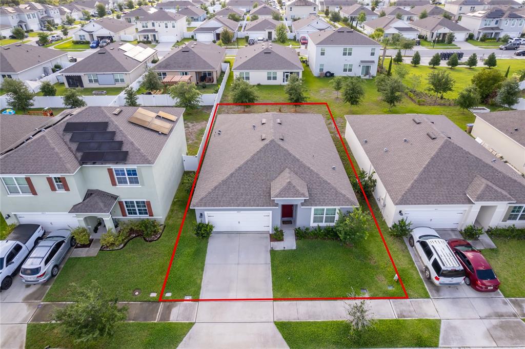 An aerial view shows four suburban houses with driveways and backyards — 2807 HARMONIA HAMMOCK ROAD, HARMONY, FL