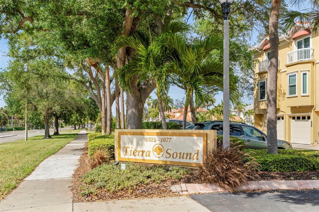 A sign for Tierra Sound stands near a sidewalk, palm trees, and a residential building — 1071 PINELLAS BAYWAY S, ST PETERSBURG, FL