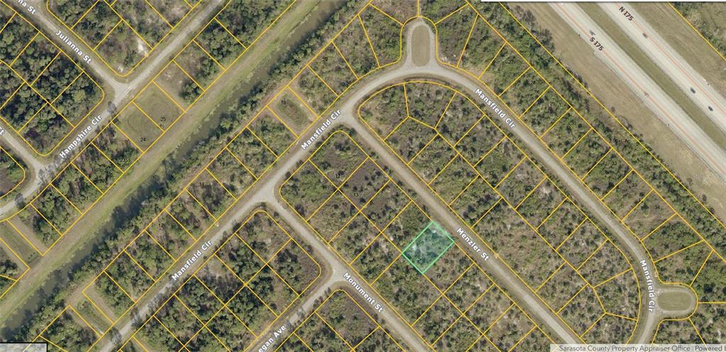 This is an aerial map showing a highlighted vacant residential lot within a suburban neighborhood — MENZLER STREET, NORTH PORT, FL