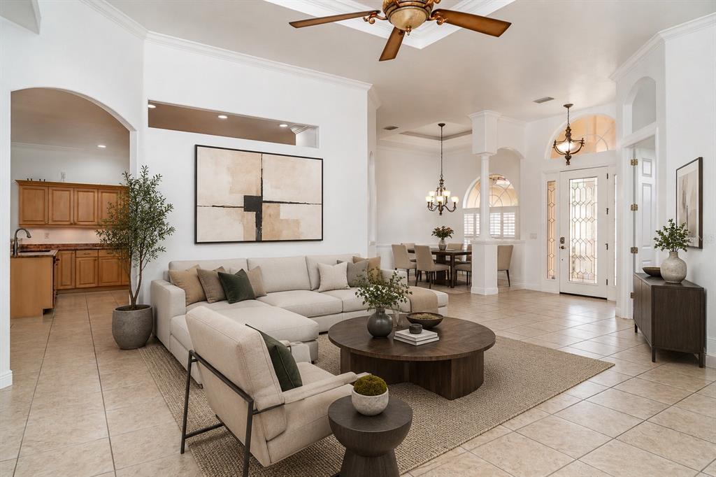 A swimming pool with a fountain sits inside a screened-in lanai behind a house — 6120 9TH AVENUE CIRCLE NE, BRADENTON, FL