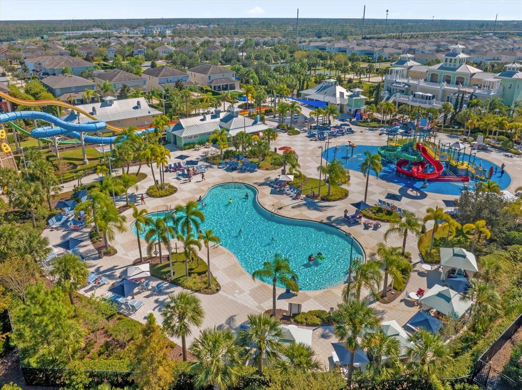 An aerial view of a community swimming pool complex with water slides and lounge chairs — 421 SOUTHFIELD STREET, KISSIMMEE, FL