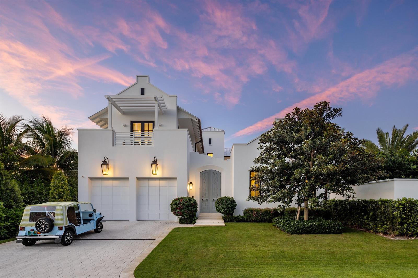 A white two-story house with a two-car garage, a light blue golf cart, and landscaping — 734 S Ocean Boulevard, Delray Beach FL 33483, DELRAY BEACH, FL